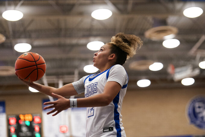 La Jolla Country Day high school point guard Jada Williams, shoots during a basketball game Friday, Nov. 18, 2022, in Chatsworth, Calif. She’s managed not to be overwhelmed by the attention, saying she considers her social media followers more like family than fans. (AP Photo/Gregory Bull)