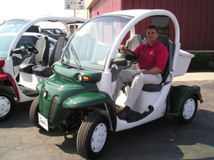 Brian Holstad, general manager at Bud's Chrysler Dodge Jeep in Celina, prepares to test drive one of the dealership's GEM electric low speed vehicles. Owned by Daimler Chrysler, the GEM electric vehicles come in several models: two-, four- and six-passenger as well as short-bed and long-bed trucks. See related photo on back page.<br></br>dailystandard.com