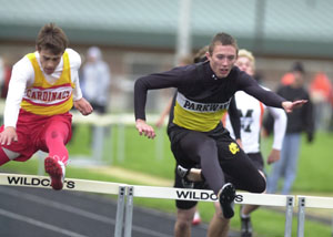 Parkway's Jacob Fox, right, clears the hurdle bar in front of New Bremen's Bryce Bergman, left, during the Midwest Athletic Conference track meet on Friday. Fox won both the 110- and 300-meter hurdle events.<br></br>dailystandard.com
