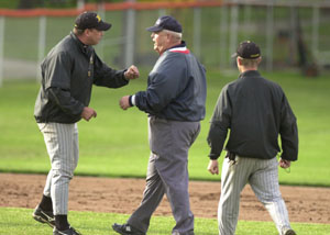 Parkway head coach Eric Stachler, left, argues with the base umpire after the final out of the game was recorded in Division III district semifinal action at Veterans Field. A controversial call to end the game sent Parkway fans home upset as Coldwater advances to Saturday's district final following its 3-1 victory over the Panthers.<br></br>dailystandard.com
