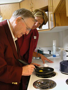 St. Marys resident John Wine prepares an egg under the watchful eye of Bonnie Quellhorst, an occupational therapist at Joint Township District Memorial Hospital in St. Marys. Patients who suffer strokes, such as Wine did in September, are taught how to perform regular household duties in the kitchenette at the hospital, as part of rehabilitation therapy.<br></br>dailystandard.com