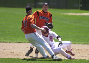 Coldwater's Sam Slavik, back, runs over to tag out Patrick Henry's Zack George during a run down as Cory Klenke, 11, joins in on the play. Patrick Henry defeated Coldwater, 6-1, in Saturday's Division III district final at Elida.<br></br>dailystandard.com