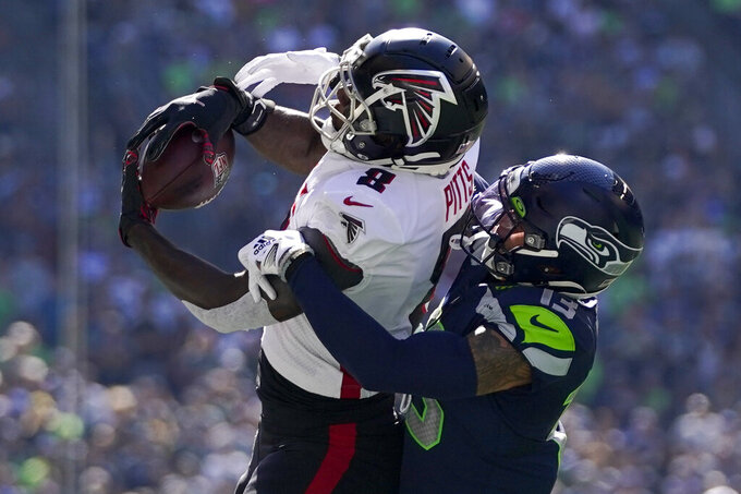 Atlanta Falcons tight end Kyle Pitts hauls in a pass as Seattle Seahawks safety Josh Jones defends during the first half of an NFL football game Sunday, Sept. 25, 2022, in Seattle. (AP Photo/Ashley Landis)