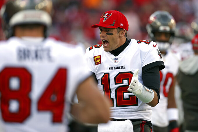 Tampa Bay Buccaneers quarterback Tom Brady (12) tries to fire up the team during the second half of an NFL divisional round playoff football game against the Los Angeles Rams Sunday, Jan. 23, 2022, in Tampa, Fla. (AP Photo/Mark LoMoglio)