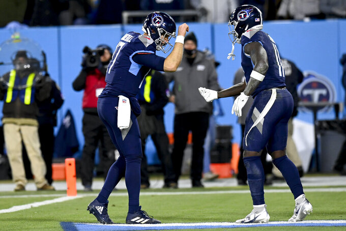 Tennessee Titans quarterback Ryan Tannehill (17) celebrates Tennessee Titans wide receiver A.J. Brown's touchdown during the second half of an NFL divisional round playoff football game against the Cincinnati Bengals, Saturday, Jan. 22, 2022, in Nashville, Tenn. (AP Photo/Mark Zaleski)