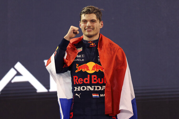 Red Bull driver Max Verstappen of the Netherlands celebrates after becoming F1 drivers world champion after winning the Formula One Abu Dhabi Grand Prix in Abu Dhabi, United Arab Emirates, Sunday, Dec. 12. 2021. (AP Photo/Kamran Jebreili, Pool)