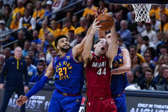 Denver Nuggets guard Jamal Murray, left, and Miami Heat center Cody Zeller (44) compete for possession of the ball during the first half of Game 1 of basketball's NBA Finals, Thursday, June 1, 2023, in Denver. (AP Photo/Jack Dempsey)
