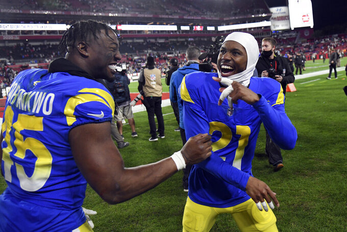 Los Angeles Rams cornerback Donte' Deayon (21) and linebacker Obo Okoronkwo (45) celebrate their win over the Tampa Bay Buccaneers during an NFL divisional round playoff football game Sunday, Jan. 23, 2022, in Tampa, Fla. (AP Photo/Jason Behnken)