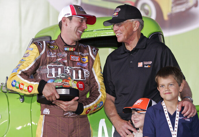 FILE - Kyle Busch, left, jokes with team owner Joe Gibbs, right, in victory lane after winning the pole position for Sunday's NASCAR Sprint Cup Series Coca-Cola 600 auto race at Lowe's Motor Speedway in Concord, N.C., Thursday, May 22, 2008. At bottom right are Ty Gibbs, left, and Colin Alpera, right. Kyle Busch will move to Richard Childress Racing next season, ending a 15-year career with Joe Gibbs Racing because the team could not come to terms with NASCAR's only active multiple Cup champion. Busch will drive the No. 3 Chevrolet for Childress in an announcement made Tuesday, Sept. 13, 2022, at the NASCAR Hall of Fame. (AP Photo/Terry Renna, File)