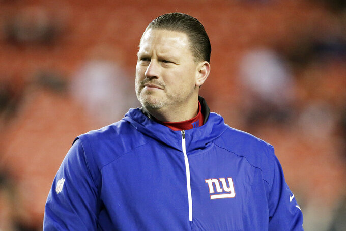 FILE - New York Giants coach Ben McAdoo stands on the field before the team's NFL football game against the Washington Redskins in Landover, Md., Nov. 23, 2017.  The Carolina Panthers are hiring former New York Giants head coach Ben McAdoo to be their new offensive coordinator, according to a person familiar with the situation.
The person spoke to The Associated Press on condition of anonymity Friday, Jan. 21, 2022. because the team is still finalizing the details of the contract. (AP Photo/Mark Tenally, File)
