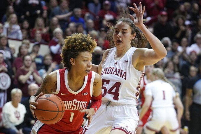 Ohio State's Rikki Harris (1) drives around Indiana's Mackenzie Holmes (54) during the first half of an NCAA college basketball game Thursday, Jan. 26, 2023, in Bloomington, Ind. (AP Photo/Darron Cummings)