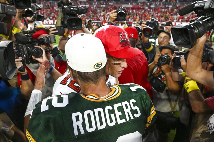 Green Bay Packers' Aaron Rodgers hugs Tampa Bay Buccaneers' Tom Brady after an NFL football game Sunday, Sept. 25, 2022, in Tampa, Fla. The Packers won 14-12. (AP Photo/Jason Behnken)